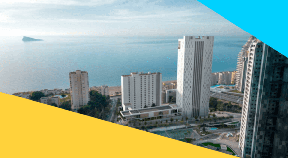 Aerial view of Benidorm’s coastline with modern high-rise buildings overlooking the Mediterranean Sea.