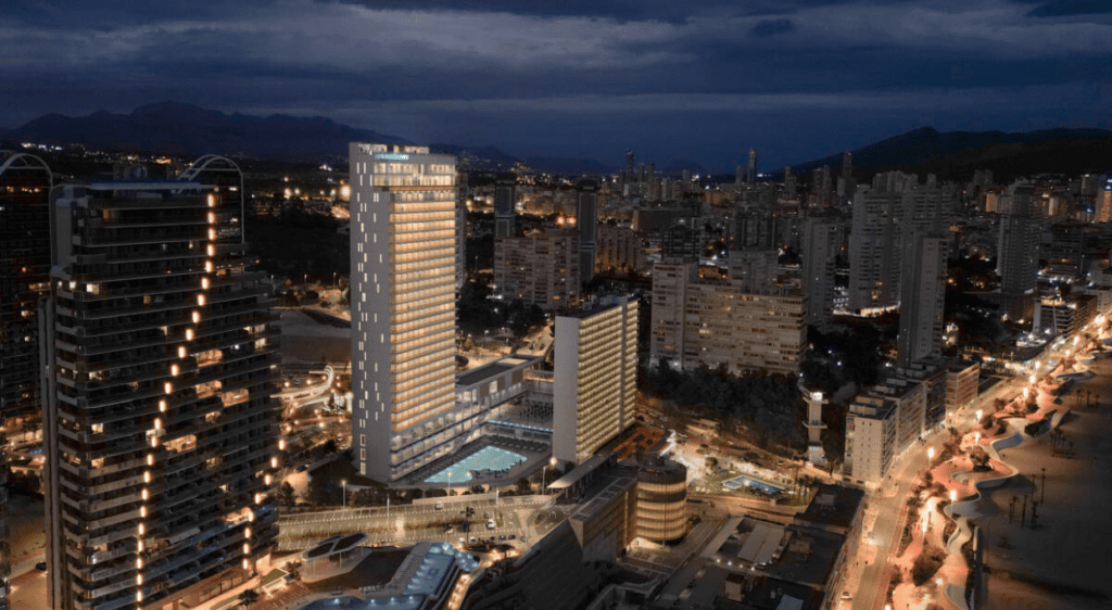 Night view of Poseidón Playas de Benidorm resort, illuminated with city lights along the Benidorm coastline.