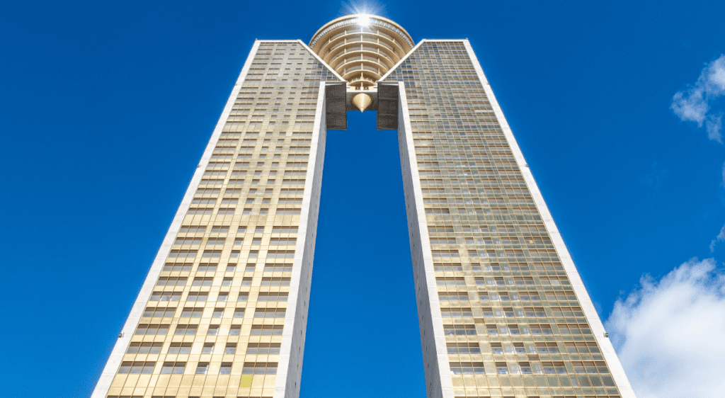 Upward view of the Intempo skyscraper in Benidorm against a clear blue sky