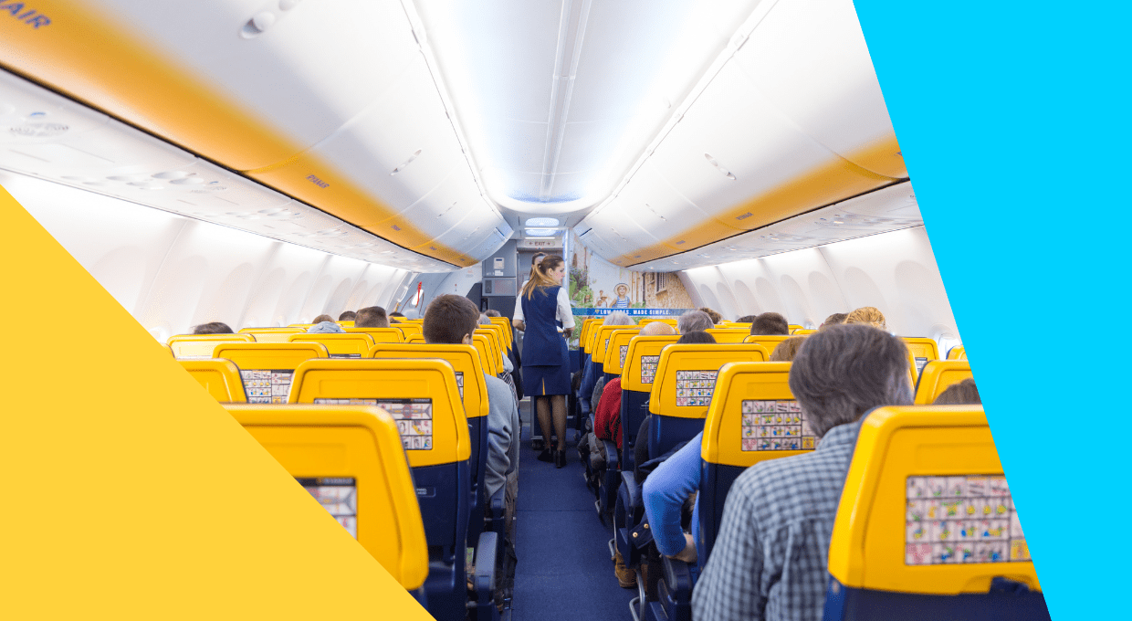 Passengers boarding a Ryanair airplane via an outdoor stairway, with the Ryanair logo visible on the aircraft.